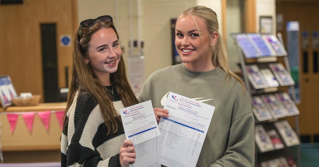 Students smiling holding results